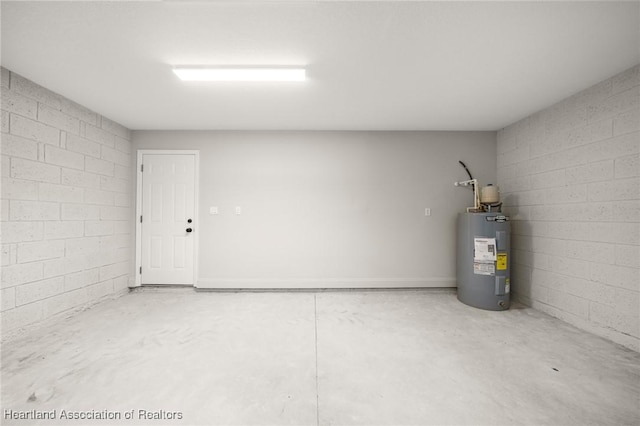 garage with concrete block wall and electric water heater
