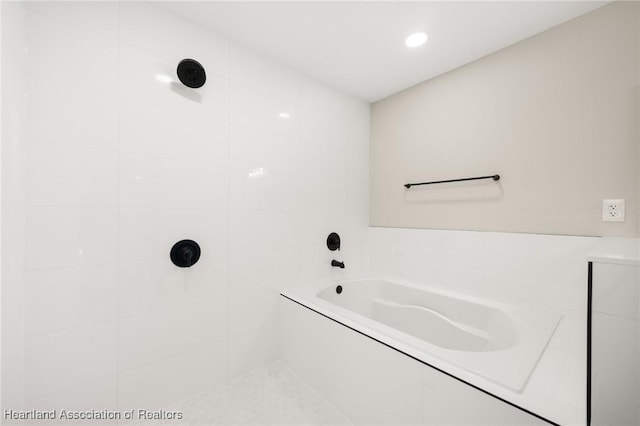 bathroom with a bath and a tile shower