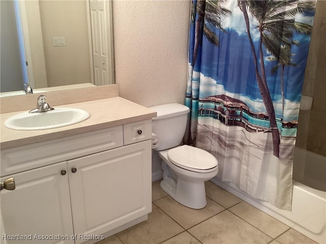 bathroom with shower / tub combo, tile patterned floors, vanity, toilet, and a textured wall