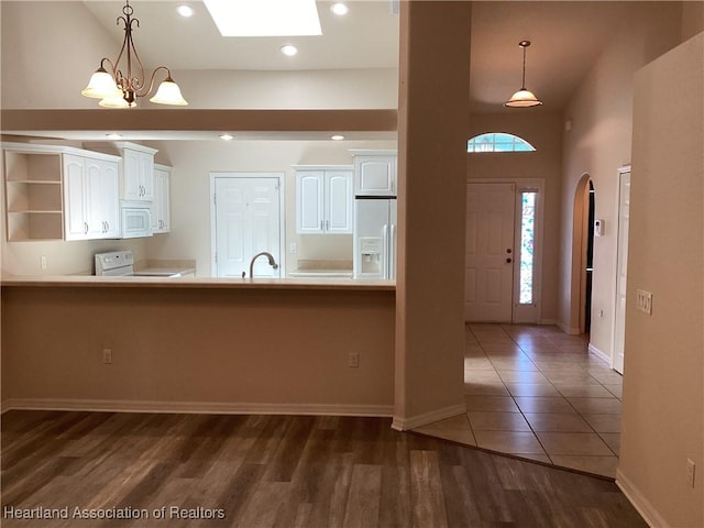 kitchen with baseboards, open shelves, white cabinetry, and white appliances