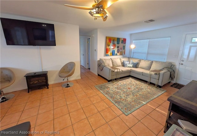 tiled living room featuring ceiling fan