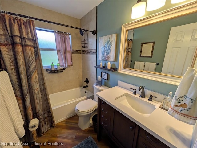 full bathroom featuring hardwood / wood-style flooring, vanity, shower / tub combo, and toilet