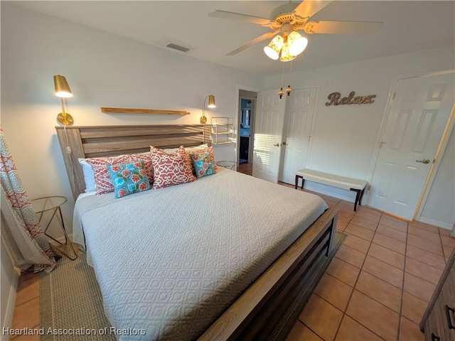 bedroom featuring light tile patterned floors and ceiling fan