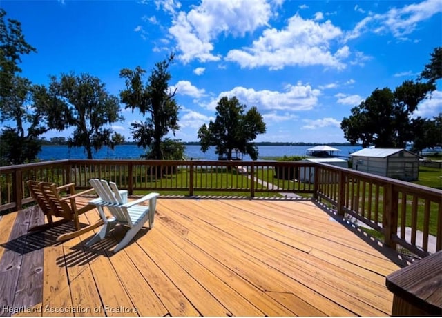 wooden terrace featuring a water view