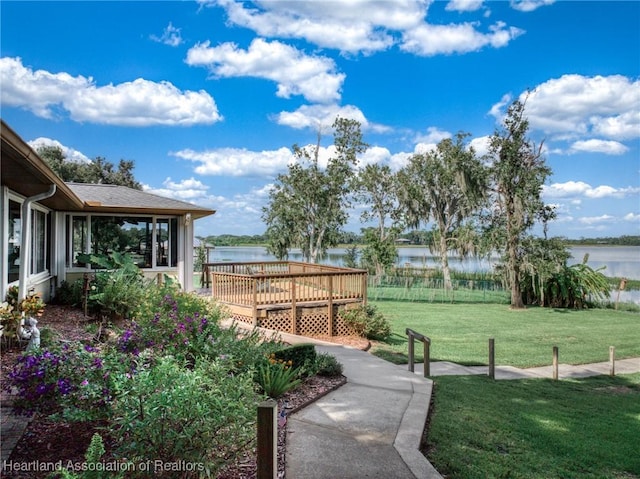 view of yard featuring a deck with water view