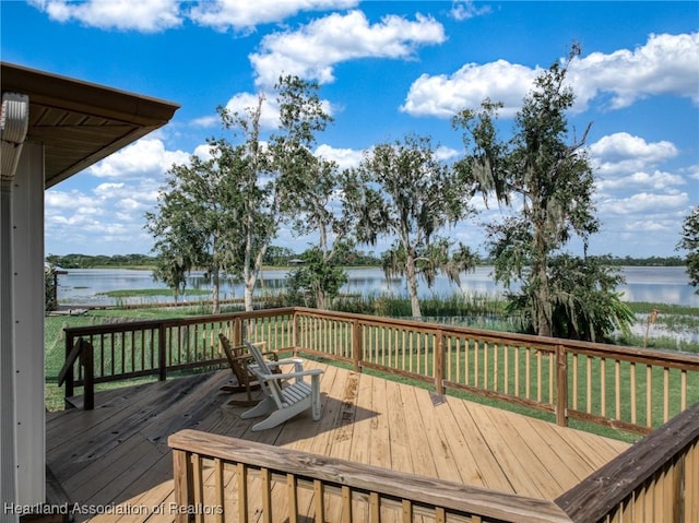 deck featuring a yard and a water view