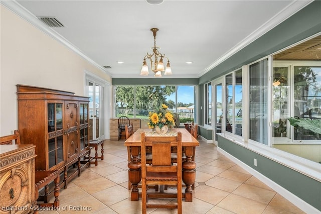 dining room with light tile patterned floors, crown molding, and a chandelier