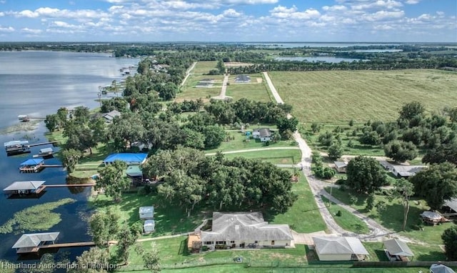 birds eye view of property with a rural view and a water view