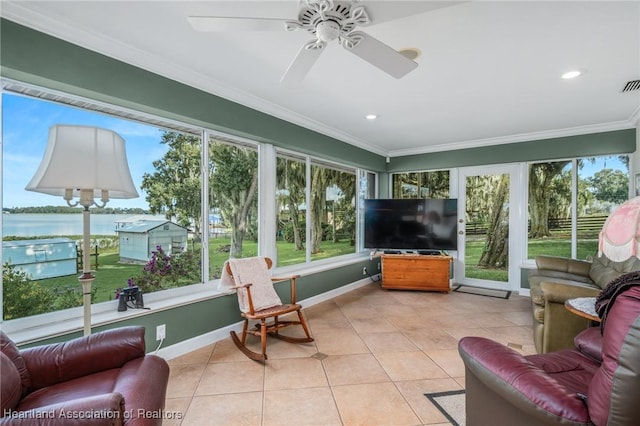 sunroom with a water view and ceiling fan