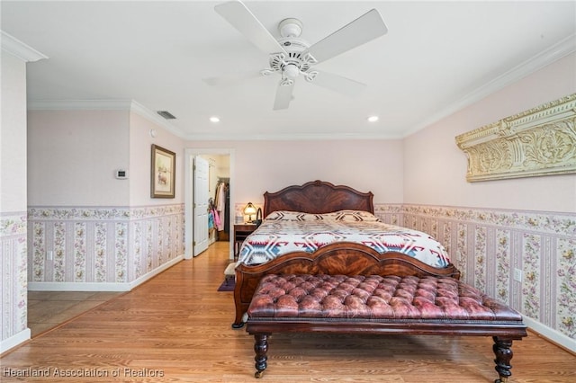 bedroom with ceiling fan, light hardwood / wood-style flooring, and ornamental molding