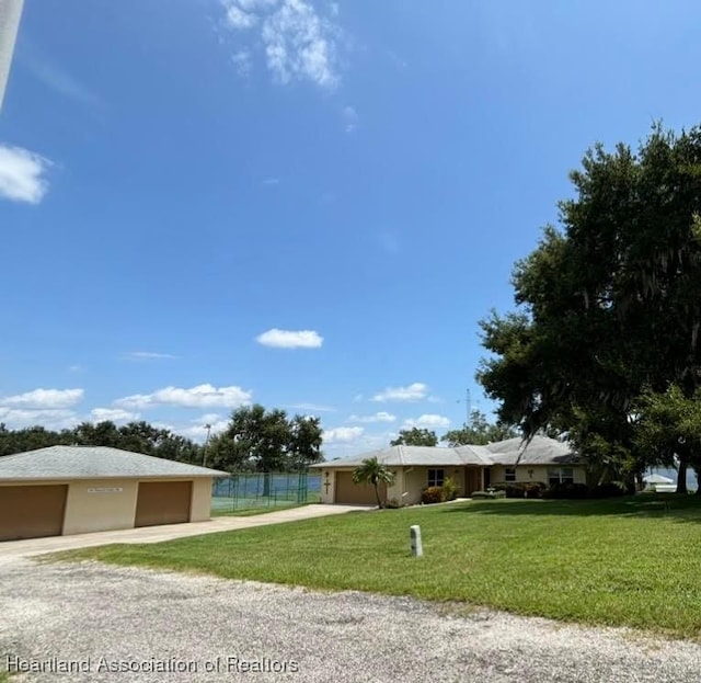 view of front facade with a garage and a front yard