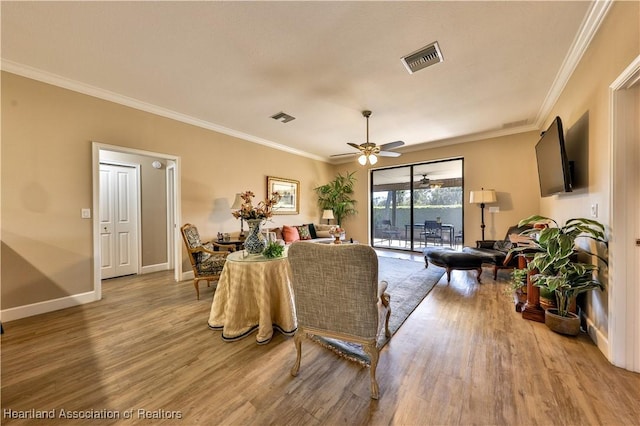 living room featuring ceiling fan, crown molding, and hardwood / wood-style flooring