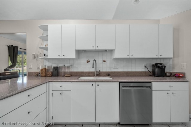 kitchen with white cabinetry, a sink, open shelves, and stainless steel dishwasher