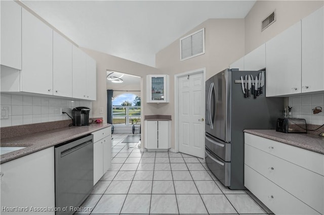 kitchen featuring lofted ceiling, white cabinets, visible vents, and dishwasher