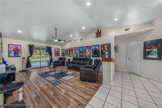 living area with vaulted ceiling, light wood finished floors, baseboards, visible vents, and ceiling fan