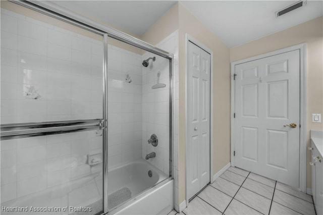 bathroom with a closet, visible vents, tile patterned floors, and enclosed tub / shower combo