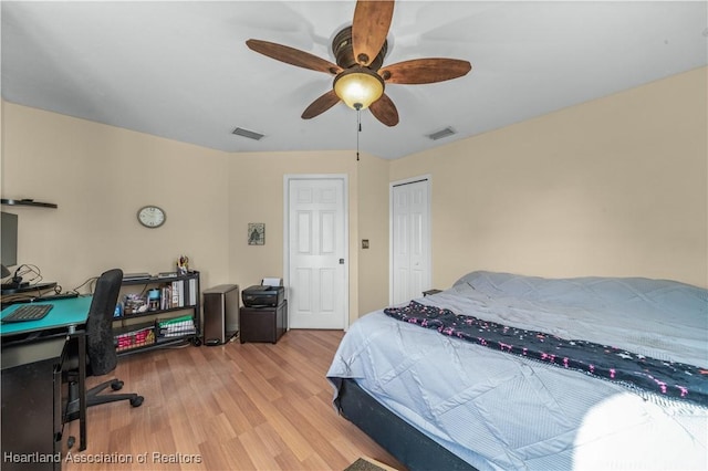 bedroom with a closet, visible vents, a ceiling fan, and wood finished floors