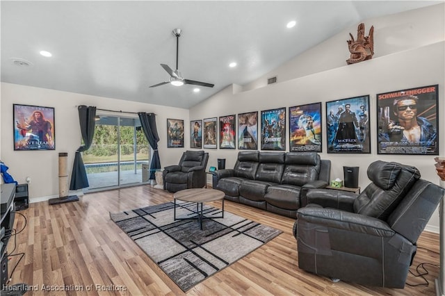 living area with ceiling fan, wood finished floors, and vaulted ceiling