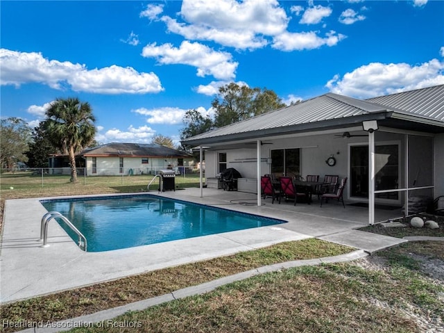 view of pool featuring a fenced in pool, fence, a patio, a lawn, and ceiling fan