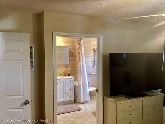 bathroom featuring a textured ceiling and vanity
