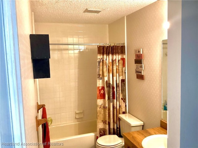 full bathroom with a textured ceiling, toilet, vanity, shower / tub combo with curtain, and wallpapered walls