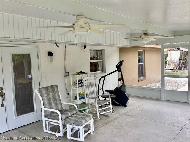 sunroom featuring ceiling fan