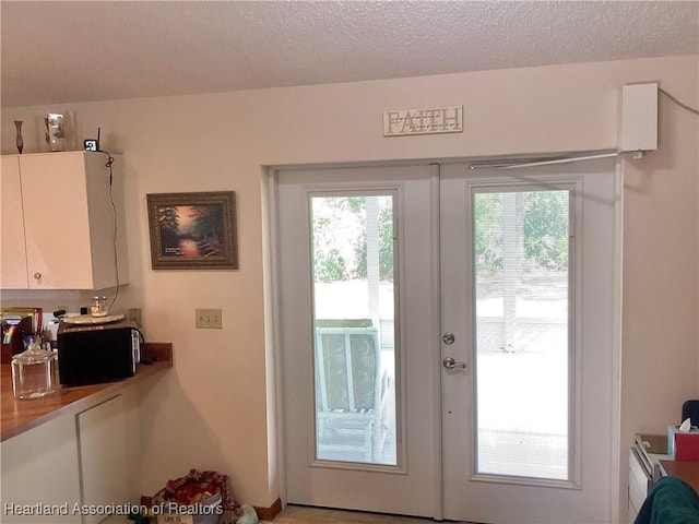 entryway featuring a textured ceiling and french doors