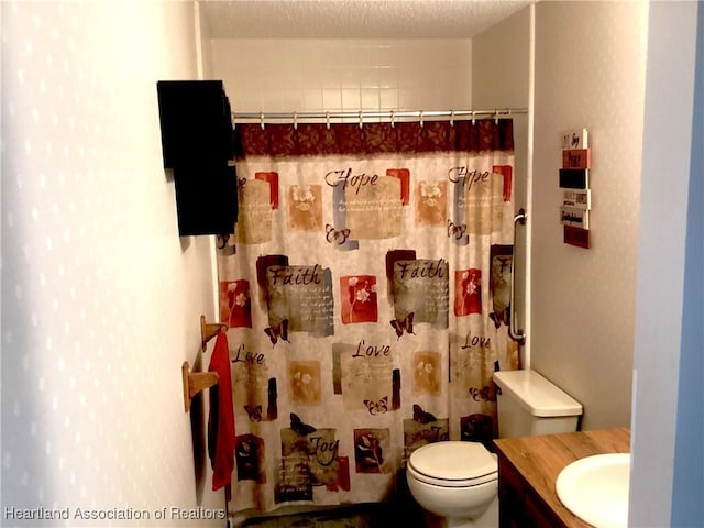 bathroom featuring toilet, a textured ceiling, a shower with shower curtain, and vanity