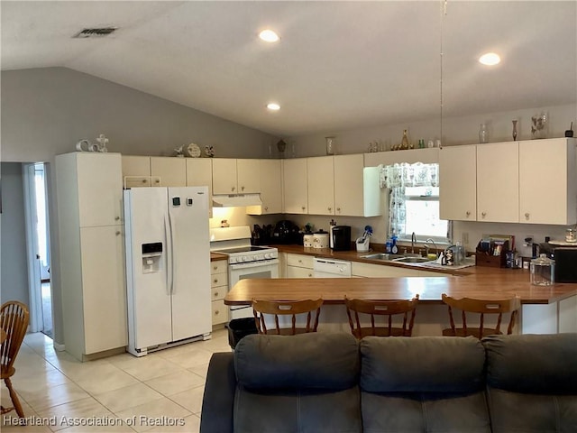 kitchen featuring visible vents, a sink, a peninsula, white appliances, and under cabinet range hood