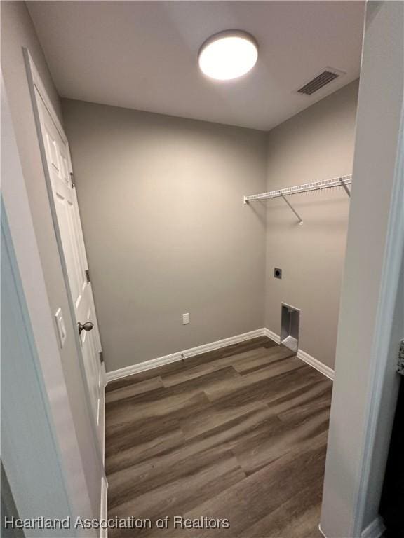 washroom featuring electric dryer hookup and dark hardwood / wood-style floors