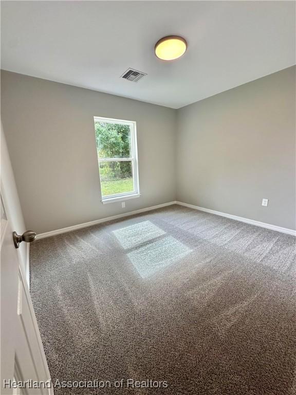 unfurnished room featuring carpet flooring