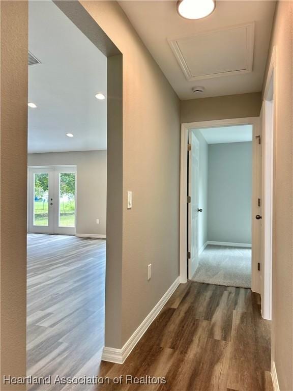 corridor with dark wood-type flooring and french doors