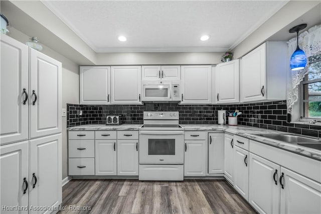 kitchen with dark hardwood / wood-style floors, white cabinets, pendant lighting, and white appliances