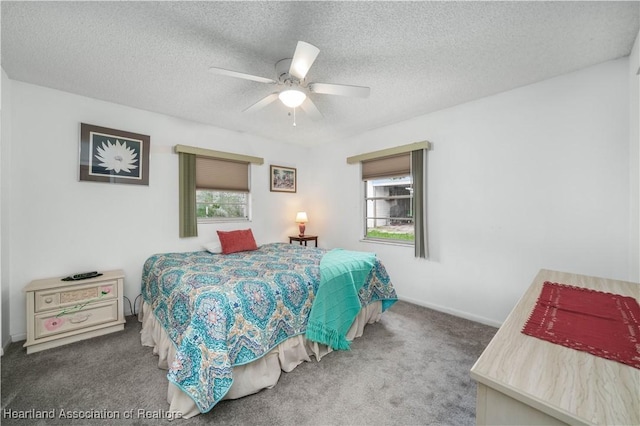 carpeted bedroom featuring a textured ceiling and ceiling fan