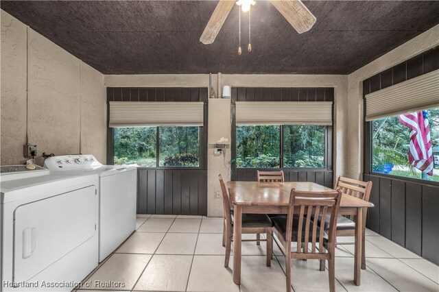 laundry area with ceiling fan, washer and clothes dryer, and light tile patterned floors