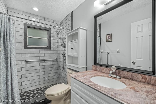 bathroom with vanity, a shower with shower curtain, a textured ceiling, and toilet