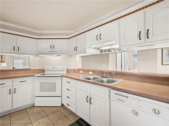 kitchen with sink, white appliances, light tile patterned floors, ornamental molding, and white cabinets