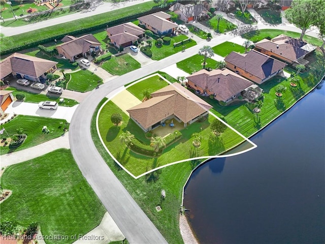 birds eye view of property with a water view