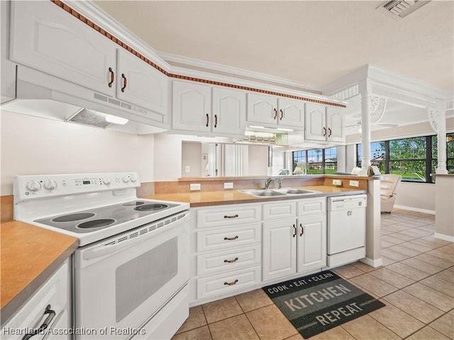 kitchen featuring white cabinetry, sink, light tile patterned floors, and white appliances