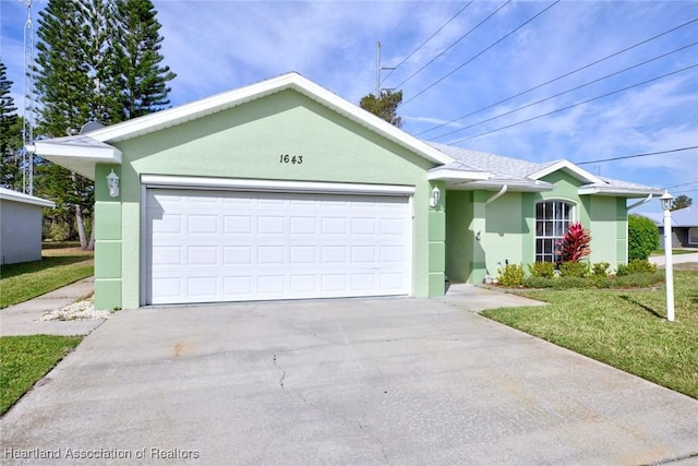 single story home featuring a garage, a front yard, concrete driveway, and stucco siding