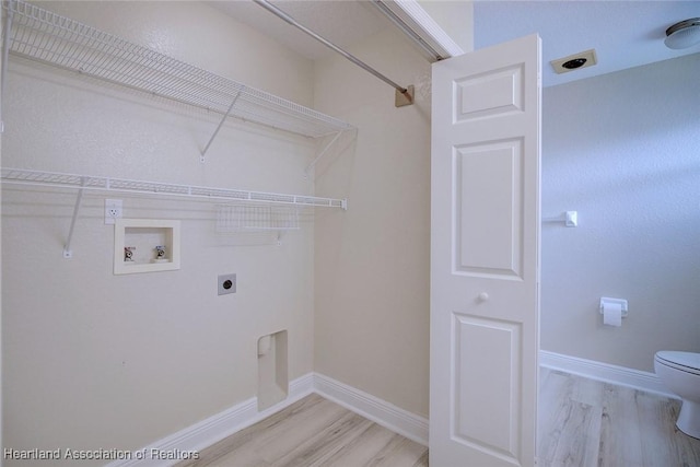 washroom featuring laundry area, hookup for a washing machine, light wood-style flooring, and hookup for an electric dryer