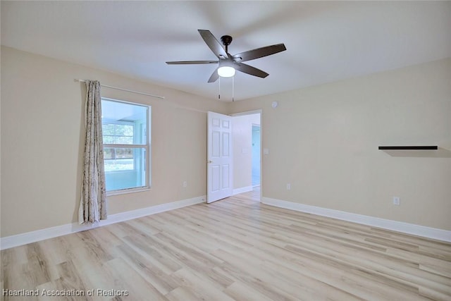 empty room with light wood-type flooring, ceiling fan, and baseboards