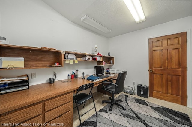 office with light carpet and a textured ceiling