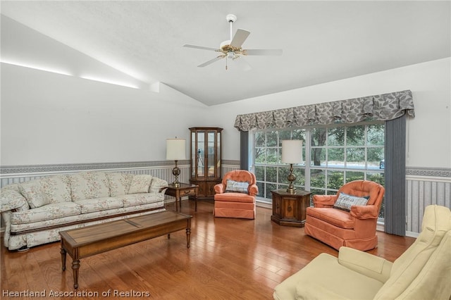 living room featuring hardwood / wood-style floors, ceiling fan, and lofted ceiling