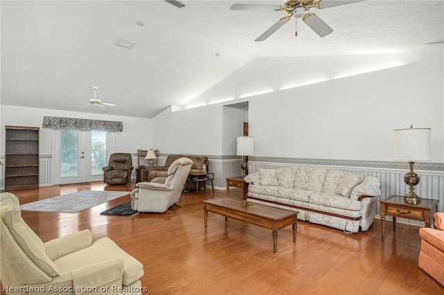 living room with ceiling fan, french doors, vaulted ceiling, and hardwood / wood-style flooring