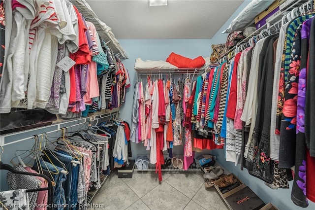 walk in closet with tile patterned floors