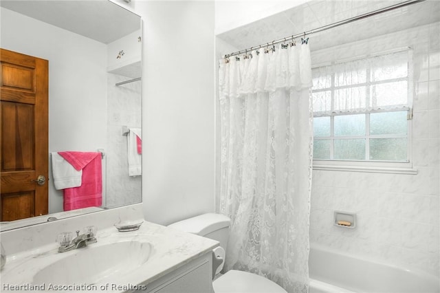 full bathroom with vanity, toilet, and shower / tub combo with curtain