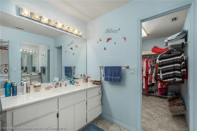 bathroom with tile patterned flooring and vanity