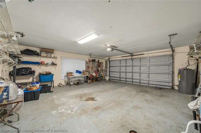 garage with electric water heater and a garage door opener