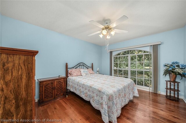 bedroom featuring wood-type flooring and ceiling fan